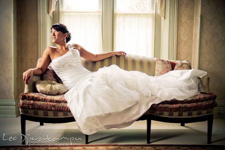 Bride with her beautiful dress lounging on the sofa. Ceresville Mansion Frederick Maryland Wedding Photo by wedding photographer Leo Dj Photography